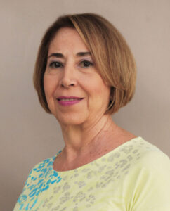 Portrait of a smiling middle-aged woman with short hair.