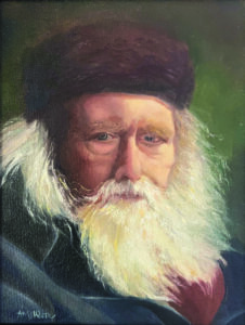 Portrait of an elderly man with a long white beard and dark hat.
