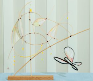 Abstract metal sculpture with geometric shapes and a butterfly motif.