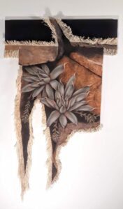 Rustic wall art featuring succulents with earthy textures and tones.