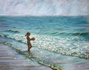 Child playing at the ocean shore, waves sparkling in sunlight.