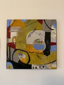 Abstract painting with bold shapes and earthy colors.