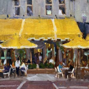 Outdoor café scene with yellow awnings and people dining.