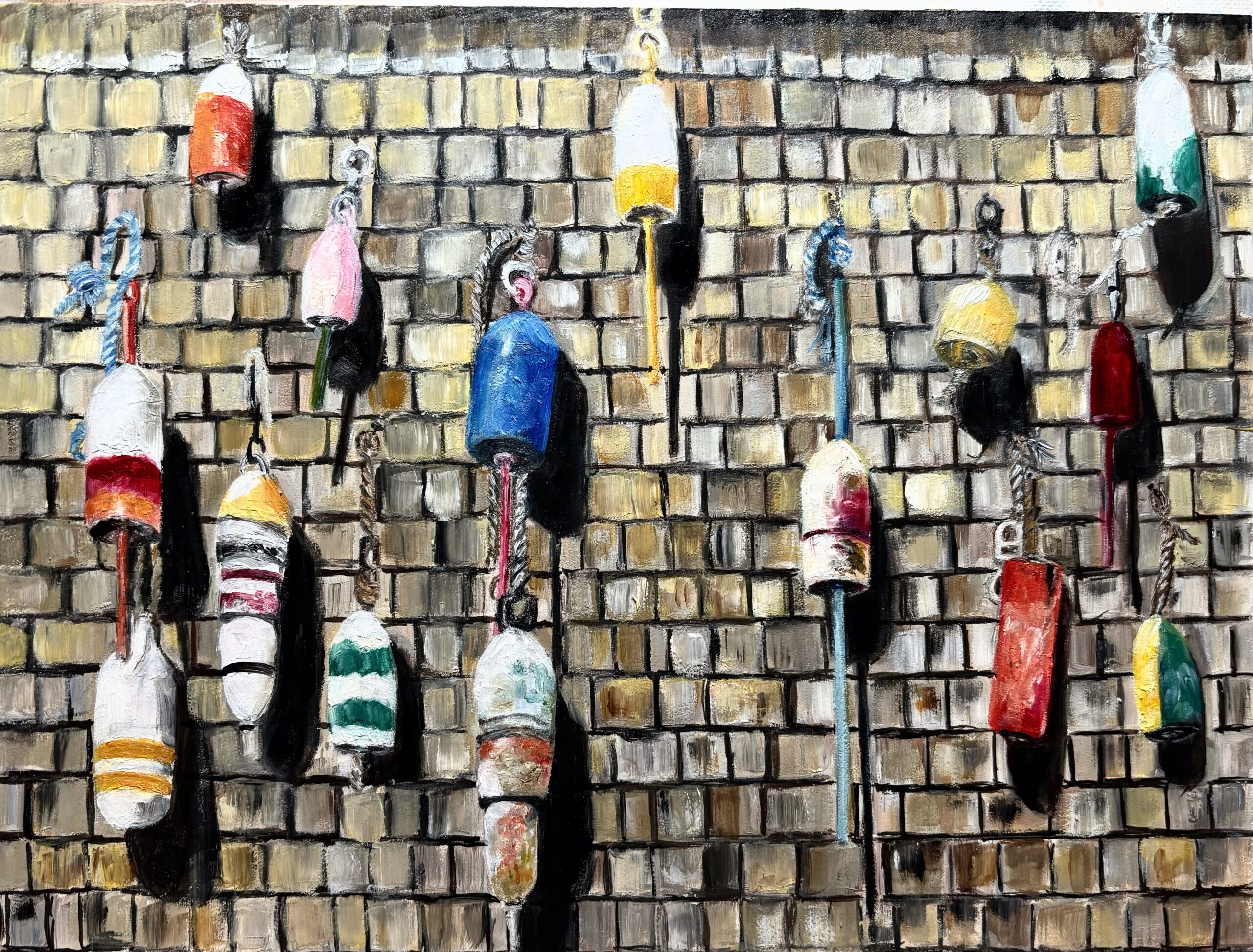 Colorful fishing buoys hanging on a wooden shingled wall.