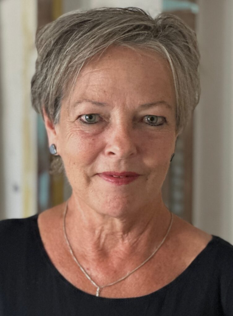 Portrait of a confident older woman with short gray hair and a subtle smile.
