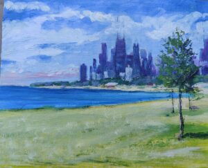 A city skyline viewed across a grassy shore under a partly cloudy sky.
