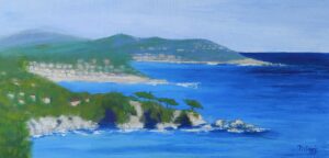 A serene coastal landscape with blue waters and green hills.