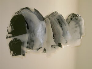 Close-up of translucent, abstract ice-like sculptures on a white surface.