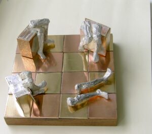 A tic-tac-toe board with wooden blocks and plastic-wrapped sticks as pieces.