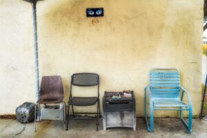 Three chairs and a small table outside.