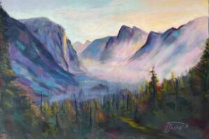 Colorful mountain landscape with trees and mist.