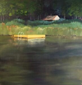 Floating dock on calm lake near forest.