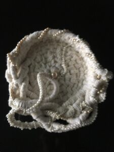 Woven basket adorned with pearl beads.