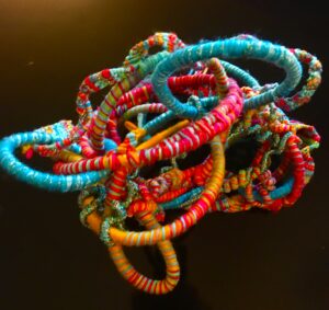 Colorful intertwined rings on dark background.