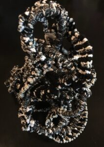 Intricate black and white yarn sculpture.