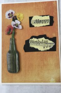 Birthday card with flowers in a bottle.